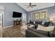 Comfortable living room with a large sectional, wood floors, and access to the balcony at 6015 Catalina Dr. # 932, North Myrtle Beach, SC 29582