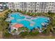 Aerial view of a resort-style pool surrounded by palm trees and lounge chairs, perfect for relaxation at 6015 Catalina Dr. # 932, North Myrtle Beach, SC 29582