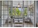 Cozy screened porch features comfortable seating, neutral decor, and views of the lush green backyard and wooded area at 6015 Catalina Dr. # 932, North Myrtle Beach, SC 29582