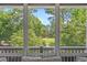 Beautiful lush landscaping and distant golf course views seen from the screened in porch of the home at 6015 Catalina Dr. # 932, North Myrtle Beach, SC 29582