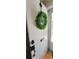Bright white front door with a green leaf wreath, modern hardware, and a secure deadbolt lock at 610 Hibiscus Ave. # 610, Myrtle Beach, SC 29572