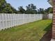 Spacious backyard featuring a well-maintained lawn and a privacy fence with storage shed at 610 Hibiscus Ave. # 610, Myrtle Beach, SC 29577