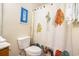 Beach themed bathroom featuring a white toilet and colorful shower curtain at 6172 Catalina Dr. # 414H, North Myrtle Beach, SC 29582