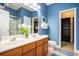 Stylish bathroom with double sinks, blue walls, and ample storage space throughout at 6172 Catalina Dr. # 414H, North Myrtle Beach, SC 29582