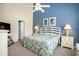 A bedroom with high ceilings features nautical decorations with warm lighting and decor at 6172 Catalina Dr. # 414H, North Myrtle Beach, SC 29582