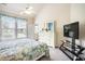 Sunlit bedroom with a view of the outdoors, complemented by a dresser and entertainment center at 6172 Catalina Dr. # 414H, North Myrtle Beach, SC 29582