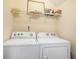 Functional laundry room with a side-by-side washer and dryer and overhead storage shelf at 6172 Catalina Dr. # 414H, North Myrtle Beach, SC 29582