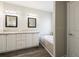 Bathroom featuring double sinks, white cabinetry and a large tub at 628 Lake Estates Ct., Conway, SC 29526