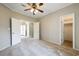 Bedroom featuring carpet flooring, ceiling fan and doorway leading to backyard at 628 Lake Estates Ct., Conway, SC 29526