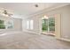 Bright living room features a sliding glass door to the backyard, neutral walls, and carpet flooring at 628 Lake Estates Ct., Conway, SC 29526