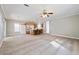 Open concept living room and kitchen with plenty of natural light and a ceiling fan to keep you cool at 628 Lake Estates Ct., Conway, SC 29526