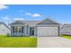 Charming single-story home featuring gray siding, a two-car garage, and a well-manicured lawn at 898 Owls Nest Dr., Conway, SC 29527