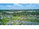 Expansive aerial view of a residential community with lush greenery, homes, and a distant ocean view at 668 Rycola Circle, Surfside Beach, SC 29575