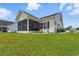 Manicured backyard, offering a view of a screened-in porch at 668 Rycola Circle, Surfside Beach, SC 29575