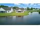 Serene backyard view of a home next to a tranquil pond, offering a peaceful outdoor setting at 668 Rycola Circle, Surfside Beach, SC 29575