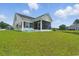 Spacious backyard showcasing a screened-in porch and pond at 668 Rycola Circle, Surfside Beach, SC 29575