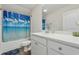 Bright bathroom featuring a white vanity, light countertop, and tub with a blue ocean-themed shower curtain at 668 Rycola Circle, Surfside Beach, SC 29575