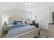 Cozy bedroom with a wooden bed frame, blue bedding, and a comfortable recliner chair at 668 Rycola Circle, Surfside Beach, SC 29575