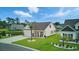 Charming home with landscaped front yard and pond, creating a serene and inviting setting at 668 Rycola Circle, Surfside Beach, SC 29575