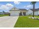 Inviting single-Gathering home featuring a brick-accented garage, well-maintained lawn, and cozy front porch at 668 Rycola Circle, Surfside Beach, SC 29575