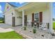 Charming front porch with a seating area and decorative wreath at 668 Rycola Circle, Surfside Beach, SC 29575