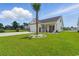 Charming single-Gathering home with a well-manicured lawn and a decorative palm tree in the front yard at 668 Rycola Circle, Surfside Beach, SC 29575