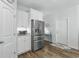 Bright kitchen area featuring stainless steel appliances, white cabinets and wood flooring at 668 Rycola Circle, Surfside Beach, SC 29575