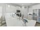 Modern kitchen with white cabinets, stainless steel appliances, and a large quartz countertop island at 668 Rycola Circle, Surfside Beach, SC 29575
