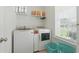 Functional laundry room with modern washer, dryer, and storage shelves for organization at 668 Rycola Circle, Surfside Beach, SC 29575