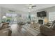 Bright living room with a fireplace, wood floors, and comfortable seating with a view of the pond at 668 Rycola Circle, Surfside Beach, SC 29575