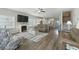 Open-concept living room with a fireplace, wood floors, and seamless flow into the kitchen at 668 Rycola Circle, Surfside Beach, SC 29575