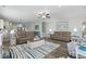 Spacious living room with modern furniture, wood floors, and ample natural light at 668 Rycola Circle, Surfside Beach, SC 29575