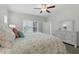 Airy main bedroom featuring wood floors, coastal decor, and a large window at 668 Rycola Circle, Surfside Beach, SC 29575