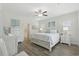 Cozy main bedroom with wood floors, white furniture, and a coastal-themed bed set at 668 Rycola Circle, Surfside Beach, SC 29575