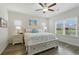Bright main bedroom featuring wood floors, coastal decor, and a ceiling fan at 668 Rycola Circle, Surfside Beach, SC 29575