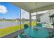 Covered patio with seating overlooking a serene pond with fountain at 668 Rycola Circle, Surfside Beach, SC 29575