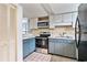 Cozy kitchen featuring painted cabinets, stainless steel appliances, and ample counter space at 6703 Jefferson Pl. # G5, Myrtle Beach, SC 29572