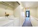 Upstairs laundry area with a washer, dryer, and storage shelves at 6703 Jefferson Pl. # G5, Myrtle Beach, SC 29572