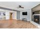 Open-concept living room featuring hardwood floors, a ceiling fan, and a cozy fireplace at 6703 Jefferson Pl. # G5, Myrtle Beach, SC 29572