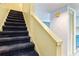 Carpeted staircase with a white handrail, leading to the upper level of the home at 6703 Jefferson Pl. # G5, Myrtle Beach, SC 29572