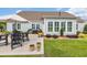 Exterior view of a home with a concrete patio, outdoor furniture, grill, and lush lawn at 700 Shell Point Ct., Longs, SC 29568