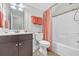 Bright bathroom featuring a shower with bathtub and peach-colored shower curtain and towels, along with modern fixtures at 700 Shell Point Ct., Longs, SC 29568