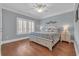 Bedroom features hardwood floors, windows with shutters, and a comfortable bed with side tables at 700 Shell Point Ct., Longs, SC 29568