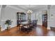 Formal dining room with hardwood floors, chandelier, wainscoting and space for a large table at 700 Shell Point Ct., Longs, SC 29568
