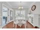 Bright breakfast nook with a round table, white chairs, and natural light from shuttered windows at 700 Shell Point Ct., Longs, SC 29568