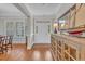 Elegant foyer featuring hardwood floors, white trim, and a decorative cabinet at 700 Shell Point Ct., Longs, SC 29568