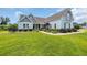 Beautifully landscaped front yard with a charming two-story home showcasing architectural details at 700 Shell Point Ct., Longs, SC 29568