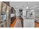 Spacious kitchen featuring granite countertops, stainless appliances, dark cabinets, and wood flooring at 700 Shell Point Ct., Longs, SC 29568
