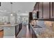 Open kitchen design with granite countertops, stainless appliances, and dark wood cabinetry at 700 Shell Point Ct., Longs, SC 29568