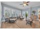 Inviting sunroom featuring wicker furniture, a ceiling fan, and natural light from multiple windows at 700 Shell Point Ct., Longs, SC 29568